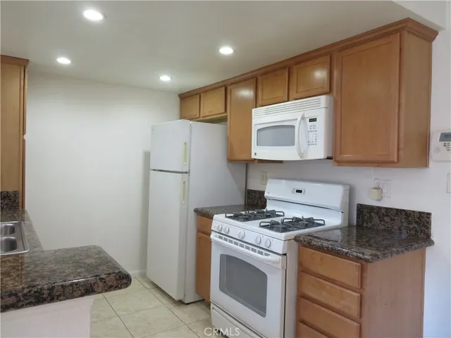 a view of room with a ceiling fan and wooden floor