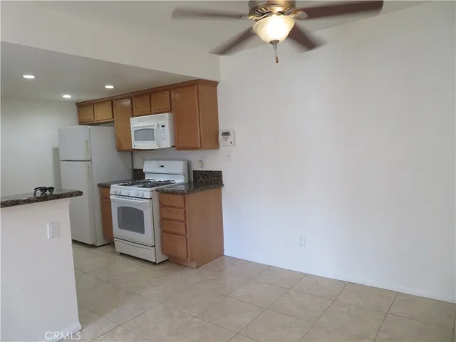 a view of kitchen with stove top oven and cabinets