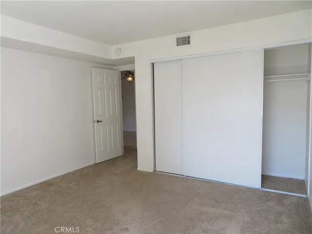 a bathroom with a granite countertop sink a toilet and mirror