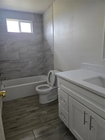 a bathroom with a toilet a sink and bathtub