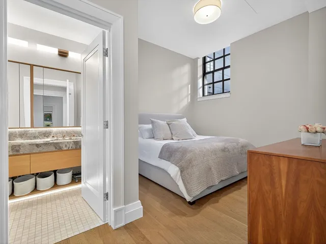 a bedroom with a bed and a mirror