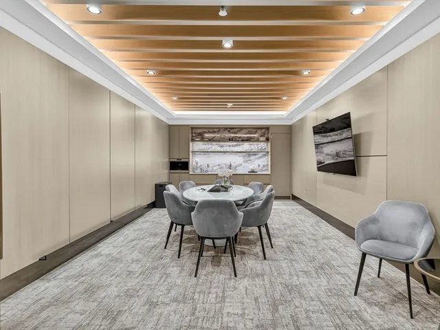 a living room with rug wall paintings and a lamp