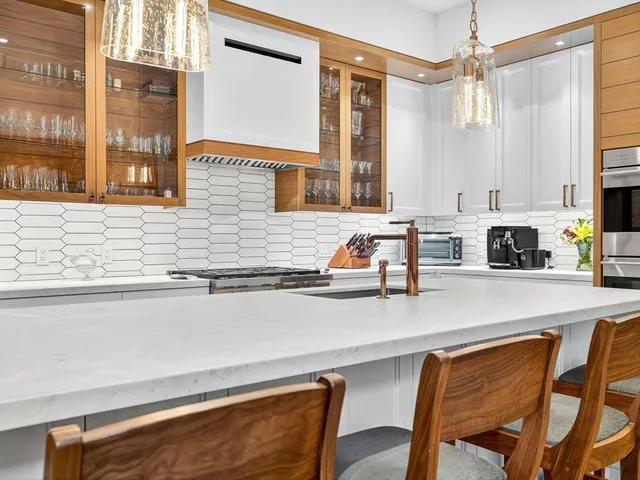 a kitchen with stainless steel appliances a sink a stove and a refrigerator
