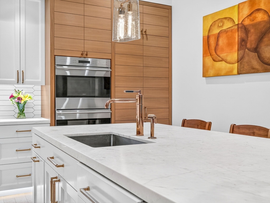 45 Temple Street, Unit 408 Boston, MA 02114 - Photo 4 of 36 a kitchen with stainless steel appliances a sink a stove and a microwave