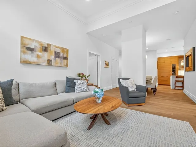 a living room with furniture a rug and a table