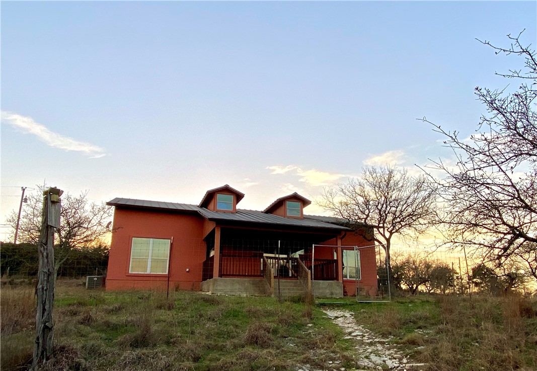 a view of a yard that has large trees and a small yard