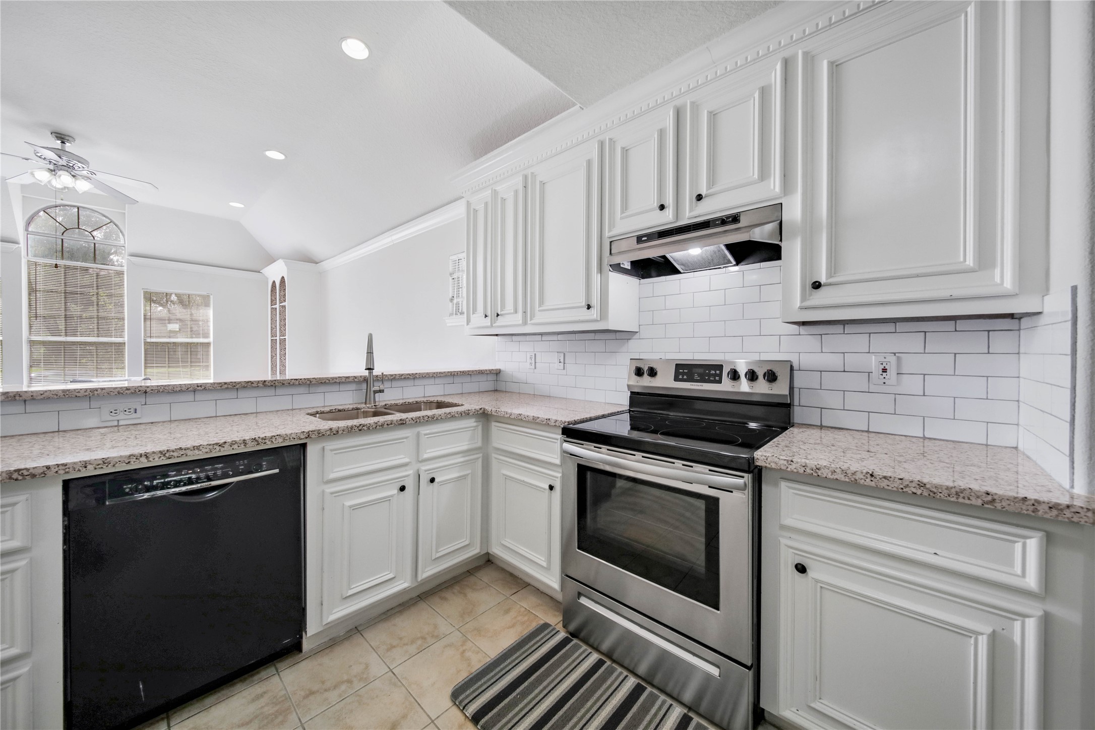 4943 Gammage Street Houston, TX 77021 - Photo 6 of 22 The kitchen boasts granite counters, a modern white subway tile backsplash, a recent sink and faucet, and all appliances included.
