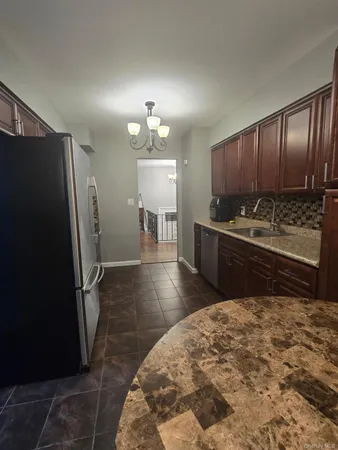 a kitchen with stainless steel appliances a sink stove and refrigerator