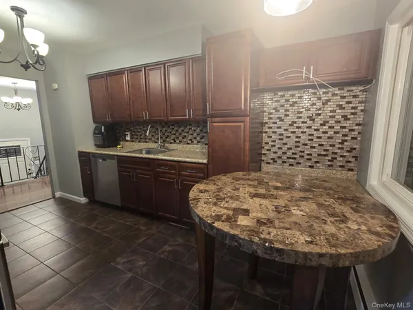 a bathroom with a granite countertop sink a toilet and shower