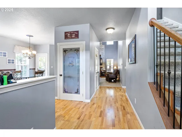 a view of a hallway view with wooden floor and living room