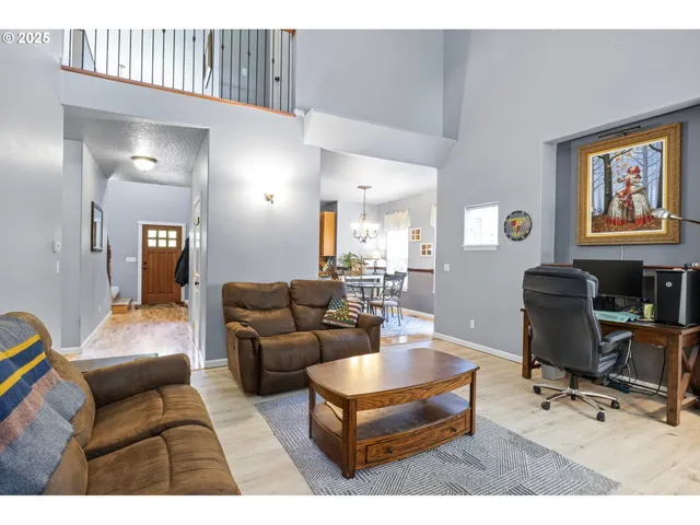 a living room with furniture a piano and a flat screen tv