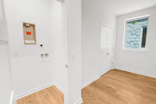 a view of empty room with wooden floor