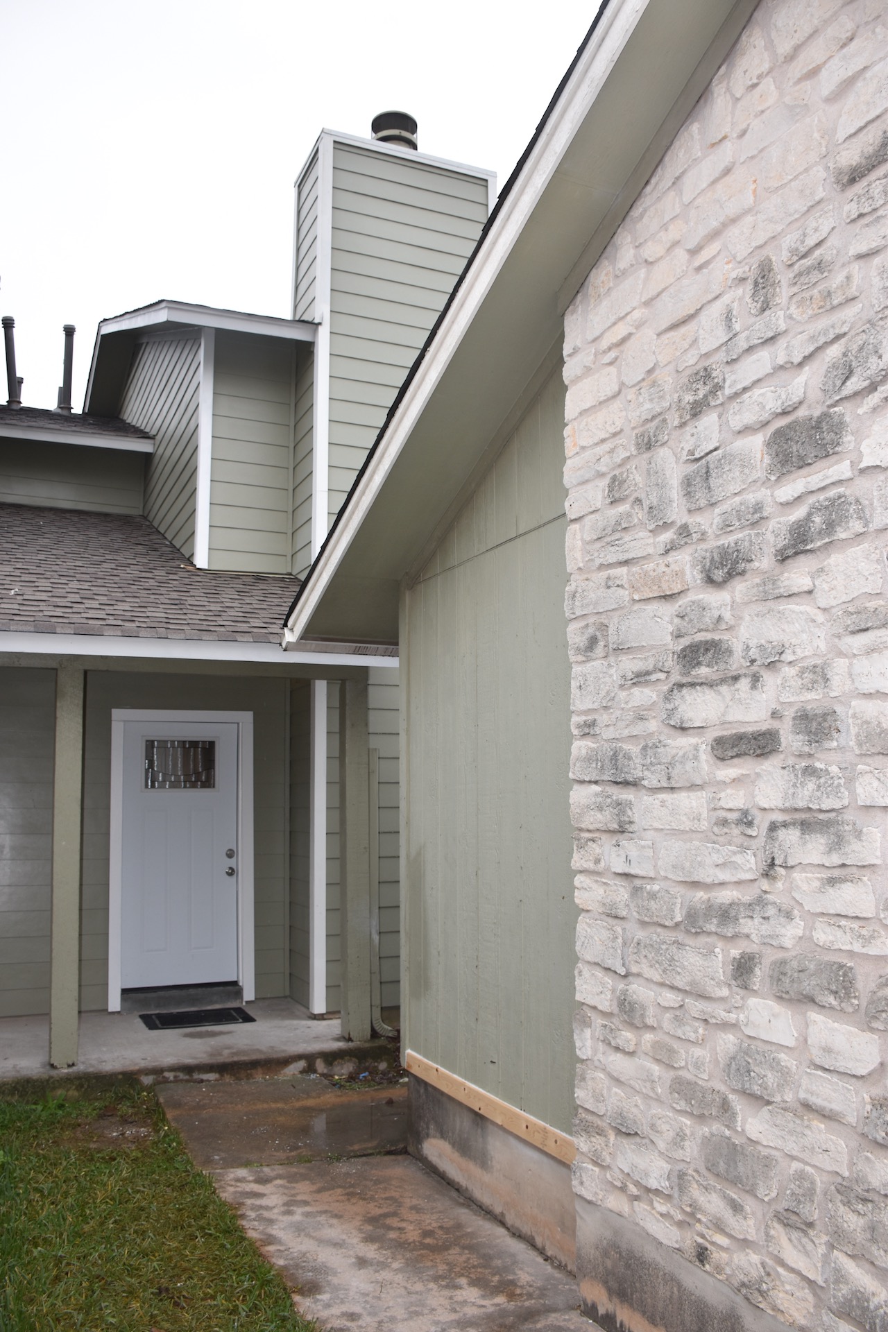 1810 Rawhide Loop Round Rock, TX 78681 - Photo 2 of 29 Exterior showcasing light green siding and stone veneer accents