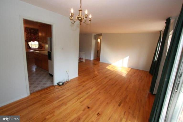 1313 Gresham Road Silver Spring, MD 20904 - Photo 2 of 28 wooden floor in an empty room with a window