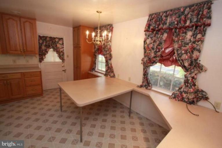 1313 Gresham Road Silver Spring, MD 20904 - Photo 11 of 28 a room with a table chair and chandelier