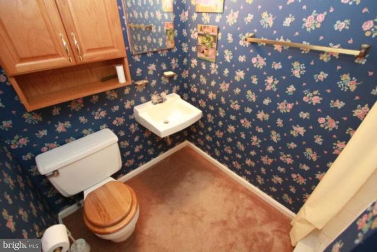 1313 Gresham Road Silver Spring, MD 20904 - Photo 13 of 28 a bathroom with a toilet sink and mirror