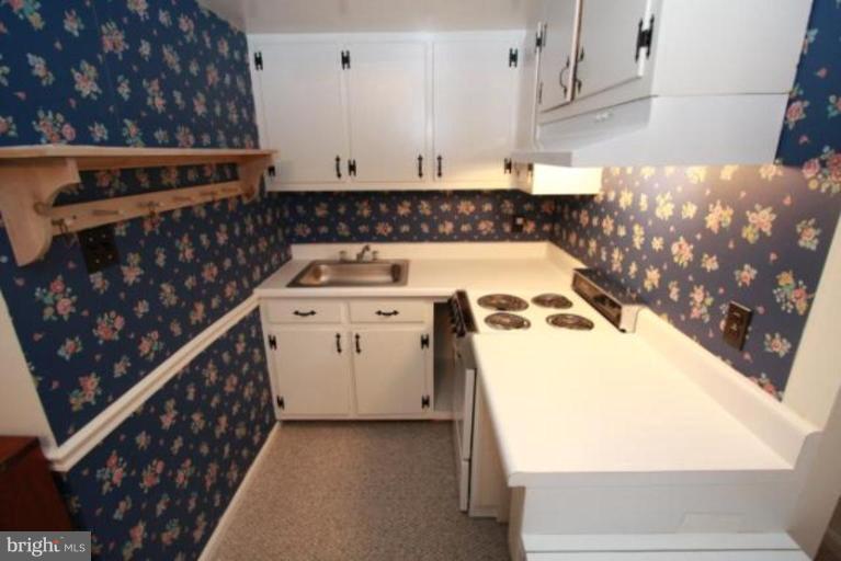 1313 Gresham Road Silver Spring, MD 20904 - Photo 17 of 28 a kitchen with a stove and a white refrigerator