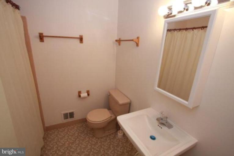 1313 Gresham Road Silver Spring, MD 20904 - Photo 18 of 28 a bathroom with a sink a toilet and shower
