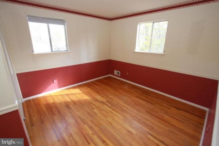 1313 Gresham Road Silver Spring, MD 20904 - Photo 20 of 28 a view of empty room with wooden floor and fan