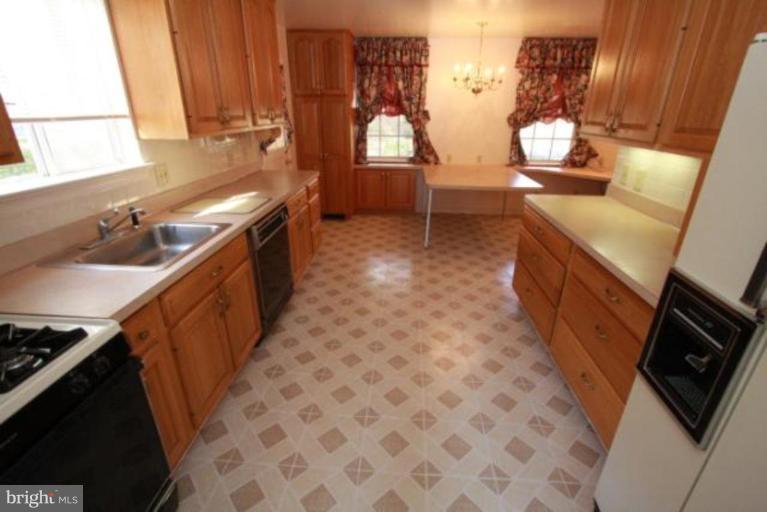 1313 Gresham Road Silver Spring, MD 20904 - Photo 4 of 28 a kitchen with sink cabinets and a stove top oven