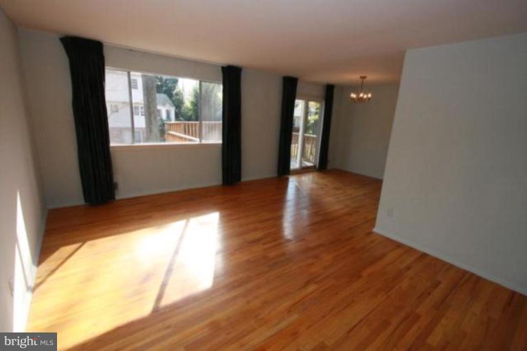 1313 Gresham Road Silver Spring, MD 20904 - Photo 6 of 28 a view of an empty room with wooden floor and a window