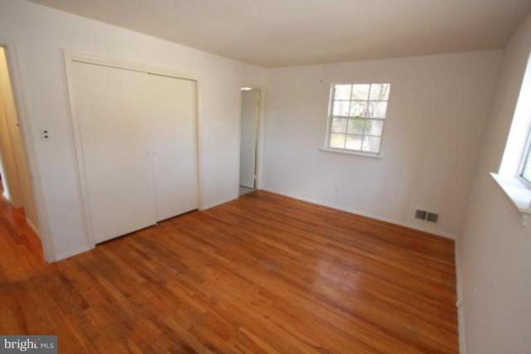 1313 Gresham Road Silver Spring, MD 20904 - Photo 7 of 28 wooden floor in an empty room with a window