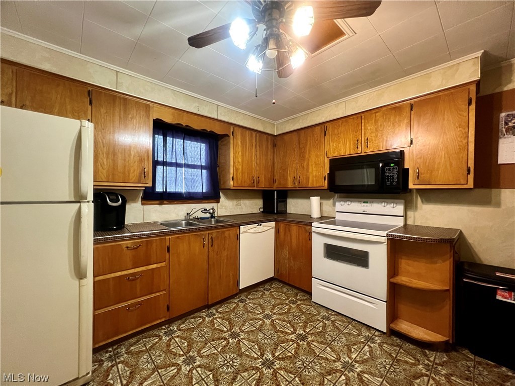229 Hilliard Road Elyria, OH 44035 - Photo 14 of 28 Kitchen with white appliances, ceiling fan, sink, and crown molding