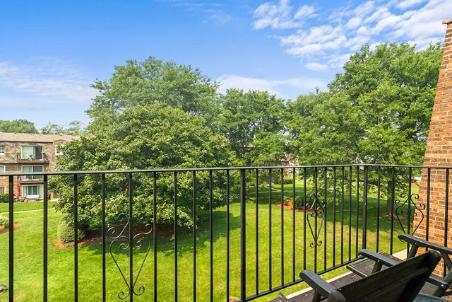 a view of a balcony with lake view and a floor to ceiling window next to a lake view