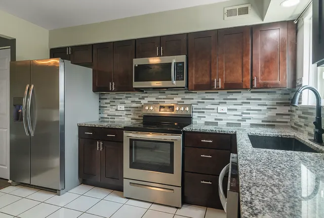 a kitchen with a sink stove and refrigerator