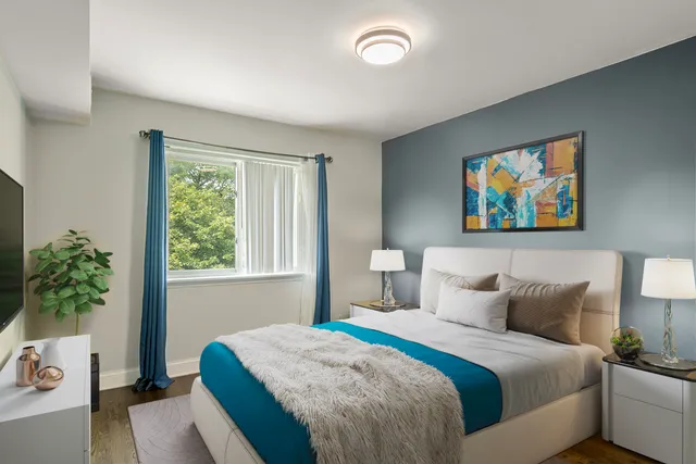 a bedroom with a bed and a potted plant