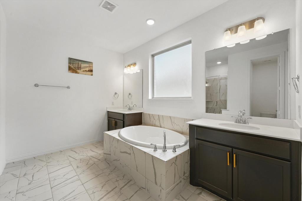 3533 Hyacinth Way Prosper, TX 75078 - Photo 17 of 38 a bathroom with a sink a toilet a mirror and vanity