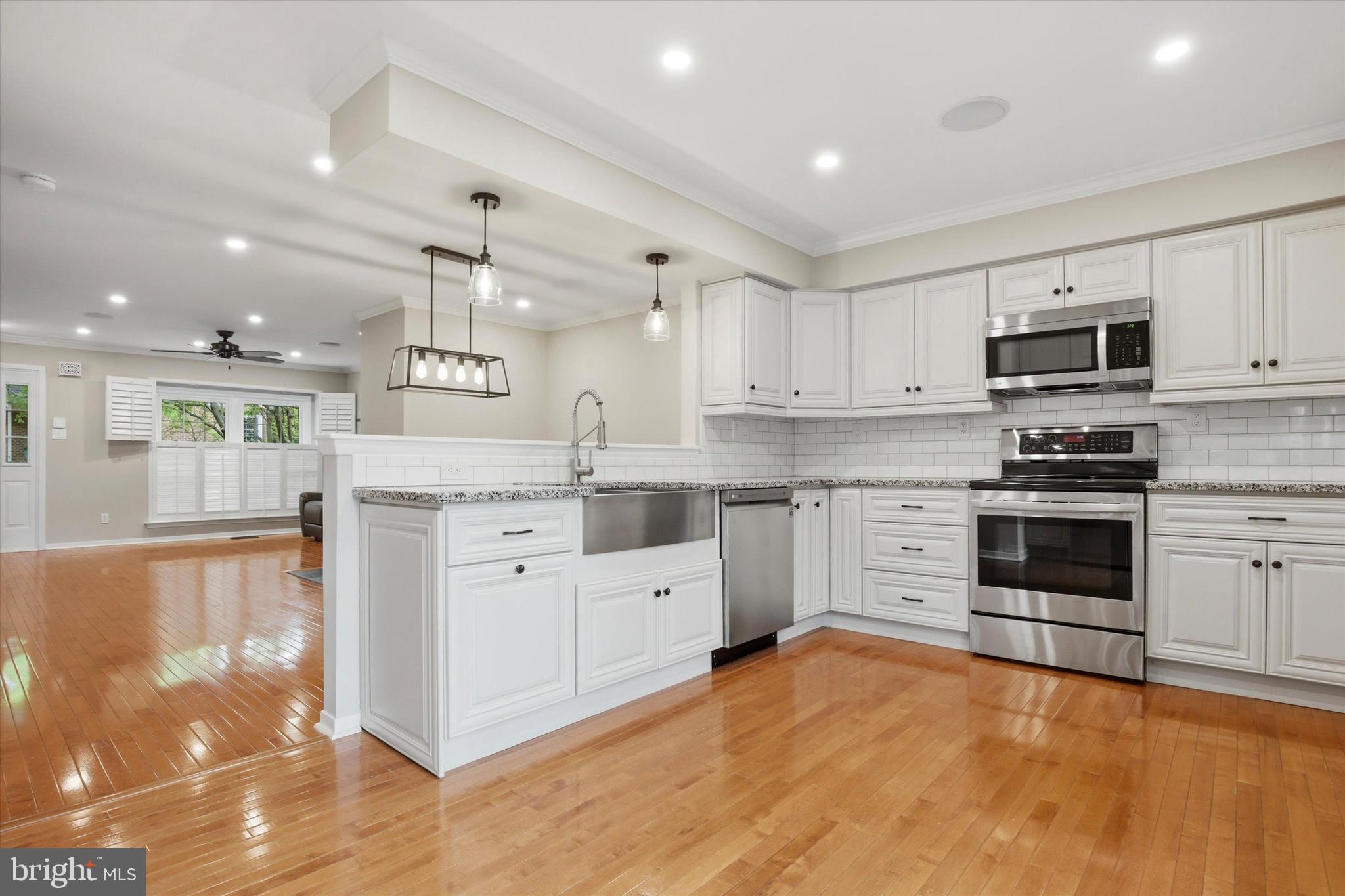 3 Windsor Circle Chesterbrook, PA 19087 - Photo 7 of 29 a large white kitchen with stainless steel appliances granite countertop a stove and a sink