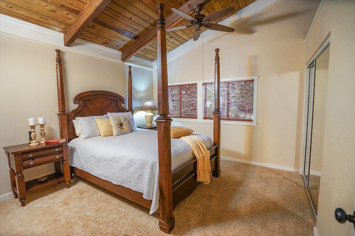 6410 Puupilo Road, Unit A1 Kapaa, HI 96746 - Photo 12 of 19 a bed sitting in a bedroom next to a lamp