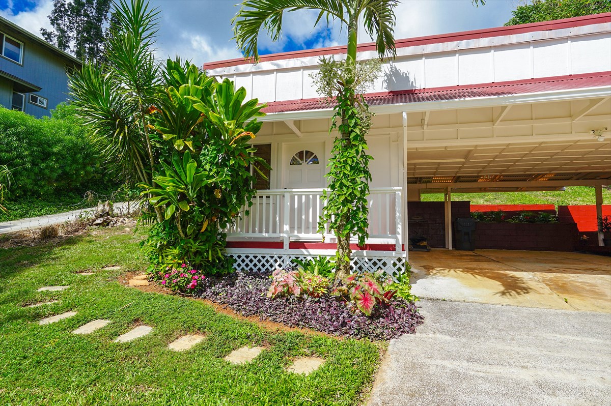 6410 Puupilo Road, Unit A1 Kapaa, HI 96746 - Photo 17 of 19 a potted plant sitting in front of a house with a yard