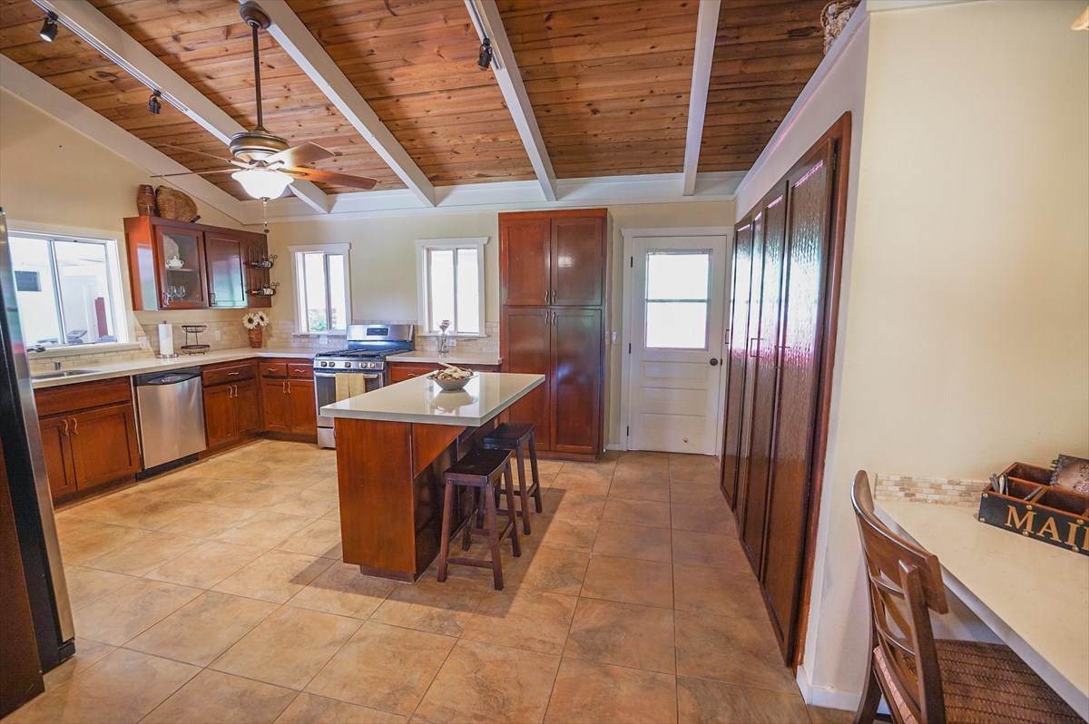 6410 Puupilo Road, Unit A1 Kapaa, HI 96746 - Photo 5 of 19 a dining hall with stainless steel appliances granite countertop a stove and a refrigerator