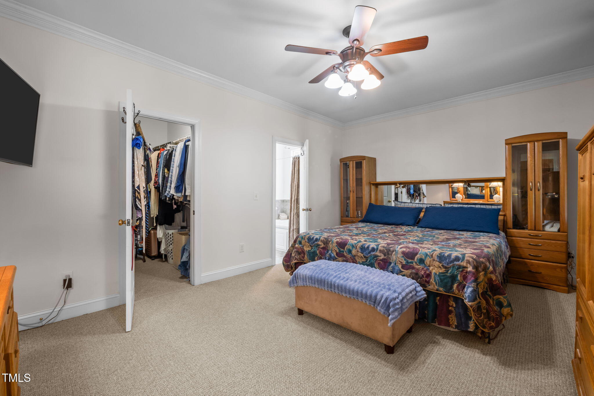9 Piney Grove Road Bahama, NC 27503 - Photo 12 of 33 a bedroom with a large bed and a chandelier