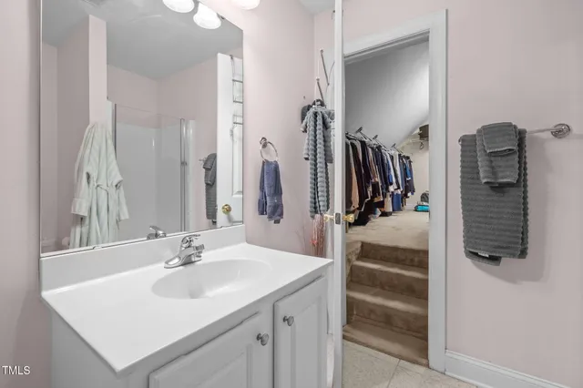 a bathroom with a sink vanity and a mirror
