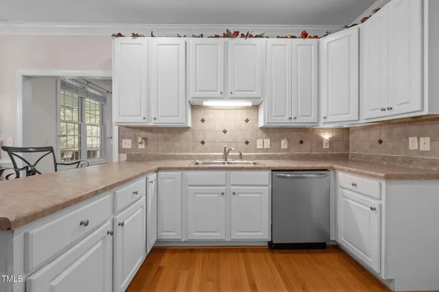 a kitchen with granite countertop white cabinets and white appliances