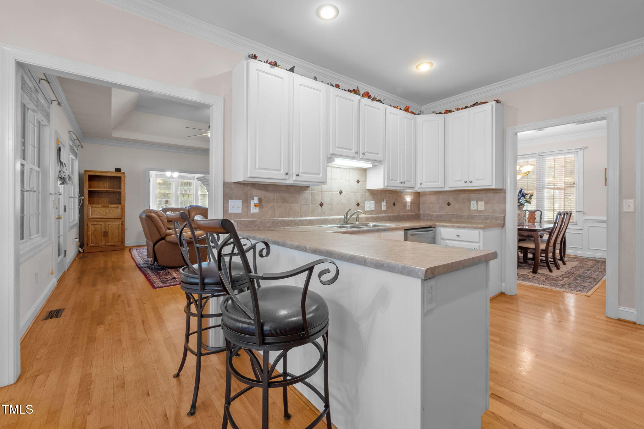 9 Piney Grove Road Bahama, NC 27503 - Photo 10 of 33 a kitchen with stainless steel appliances kitchen island granite countertop a table chairs sink and cabinets