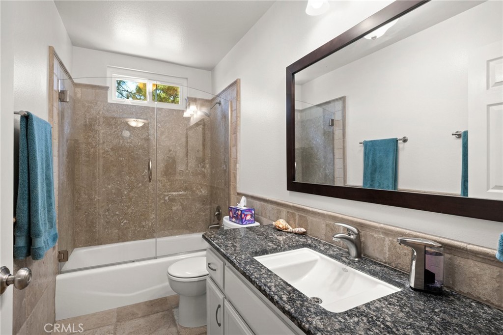 2532 Briar Glen Road Acton, CA 93510 - Photo 16 of 48 a bathroom with a granite countertop sink toilet and shower