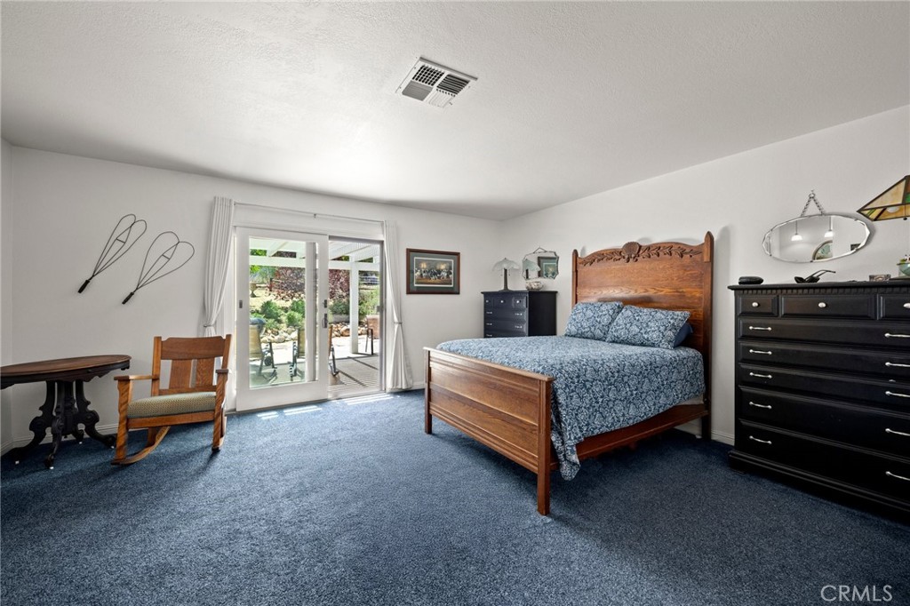 2532 Briar Glen Road Acton, CA 93510 - Photo 17 of 48 a bedroom with a bed and a chandelier