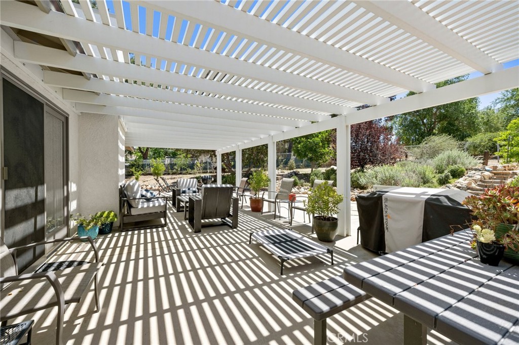2532 Briar Glen Road Acton, CA 93510 - Photo 23 of 48 a view of a patio with table and chairs barbeque potted plants and large tree
