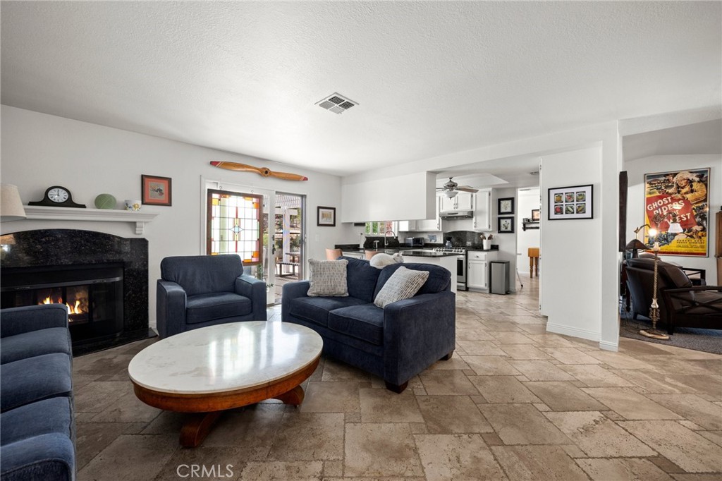 2532 Briar Glen Road Acton, CA 93510 - Photo 7 of 48 a living room with furniture a fireplace and a flat screen tv