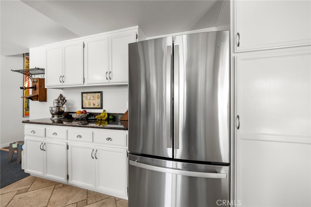 2532 Briar Glen Road Acton, CA 93510 - Photo 9 of 48 a kitchen with stainless steel appliances granite countertop a refrigerator and white cabinets