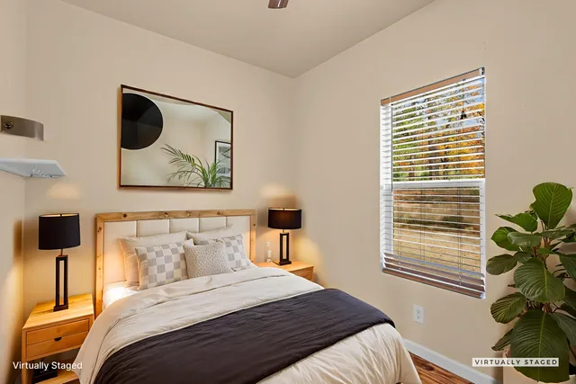 a bedroom with a bed and a potted plant
