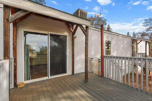 a view of a house with a wooden deck