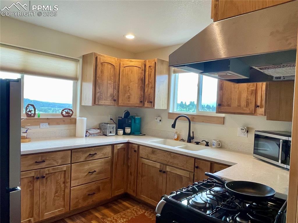 291 Junkins Loop Westcliffe, CO 81252 - Photo 10 of 41 a kitchen with a sink stove and cabinets