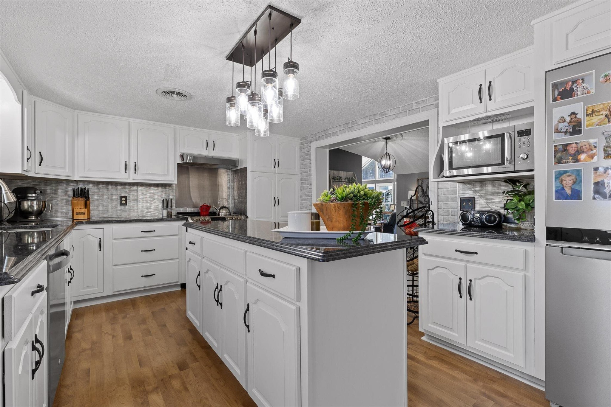 5017 McDonald Road McDonald, TN 37353 - Photo 15 of 52 a kitchen with stainless steel appliances granite countertop a sink cabinets and wooden floor