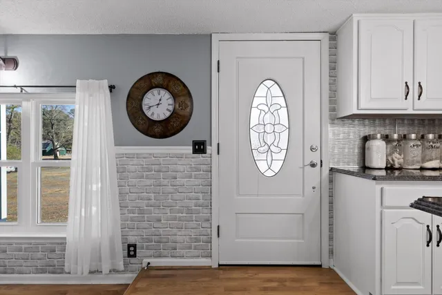 a bathroom with a clock and a window