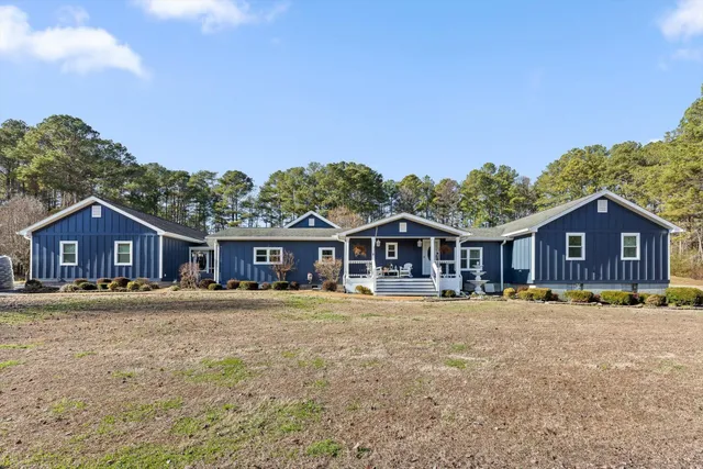 a big house with a big yard and large trees